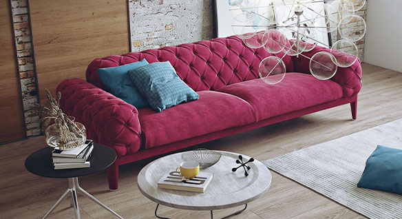 Rendering of modern living space dominated by plush, berry-colored velvet Chesterfield sofa