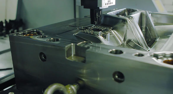 Electrical discharge machining being used to add small details to an injection mold tool
