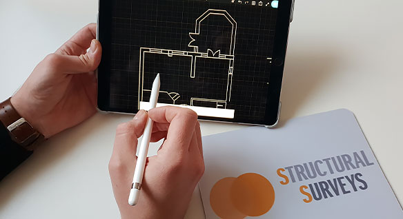A surveyor drafts a design on a tablet with the AutoCAD mobile app