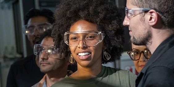 Smiling woman wearing safety glasses